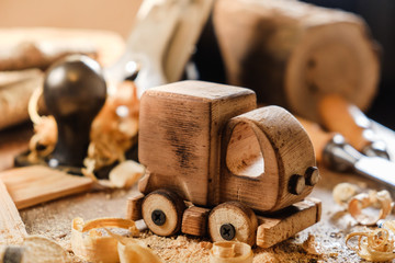 Wooden toy truck van car on the carpentry workbench. Hobby diy crafts, making