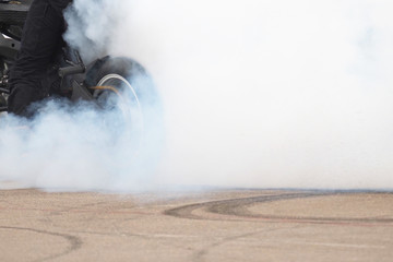 Smoke from under the rear wheel of a motorcycle with the drift. Moto drift