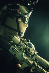 Shoulder portrait of army elite troops sniper, anti-terrorist tactical team marksman wearing helmet...