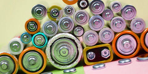 Many different types used or new battery, rechargeable accumulator, alkaline batteries on color...