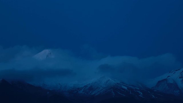 Timelapse Sunset of the volcano. Sunshine over high mountain peak. Timelapse Movie of Beautiful Sunset Scene Mountain . Sunset over volcano with stars in the night sky. 4K