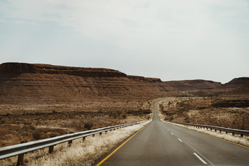 lonely street through canyon in Namibia, Africa from Keetmanshoop towards Luederitz