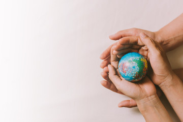 Hands couple holding globe, love, valentine, health care, donation and family insurance concepts, World Heart Day, save world, prayer.