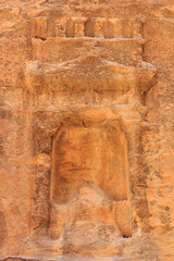 Niche containing sacred stone Baetyl at gorge canyon Siq in ancient city of Petra in Jordan