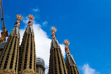 spires of sagrada familia cathedral against blue sky
