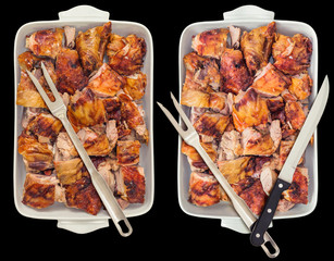 Fresh Spit Roasted Pork Thigh Meat Slices Offered in White Ceramic Casserole Pan With Serving Cutlery Isolated on Black Background