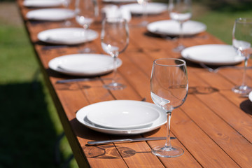 Served wooden table without a tablecloth. Cafe in the open air park
