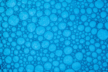Abstract blue background with soap bubbles in the water. Close-up. Macro.