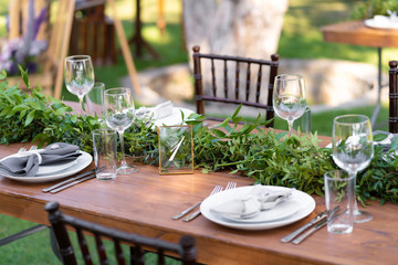 Preparing for an open-air party. Decorated with fresh flowers served tables. Table number. Decoration Details