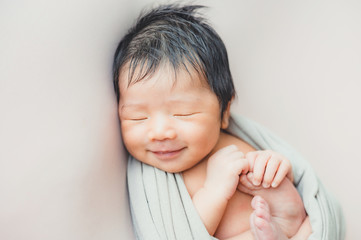 Asian newborn baby sleeping in blanket on bed - obrazy, fototapety, plakaty