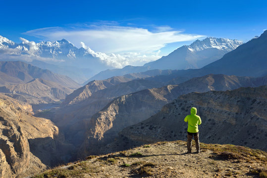 Man stands on the peak of rock