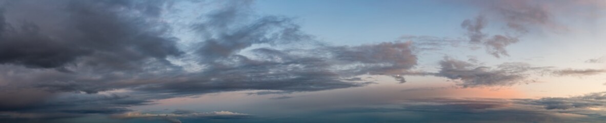 Fototapeta na wymiar Fantastic dark thunderclouds, natural sky composition - wide panorama