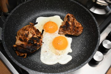 Scrambled eggs and meat in a frying pan