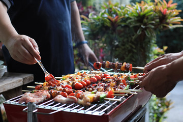 Barbeque Grill Street Food in thailand,Eat outdoors in a happy family.