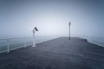 Wooden jetty by the sea on a foggy morning. Baltic Sea Gdynia, Poland