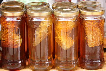 Fresh honey in glass bottles are on sale in the market