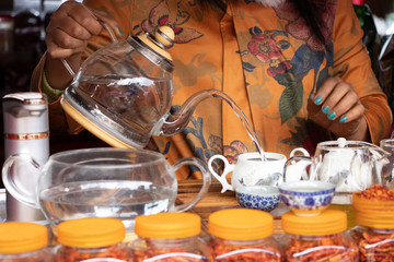 Tea shop staff demonstrating tea brewing