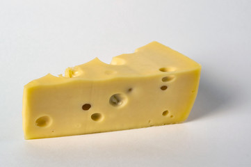 Delicious piece of cheese on white background