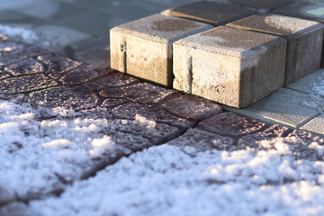 Bricks of building materials in anticipation of stoic work lie on the street