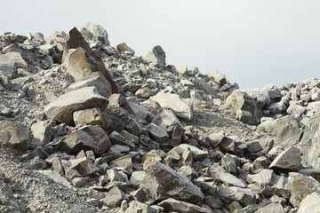 Large fragments of stone ore in a quarry for the extraction of limestone, close-up.