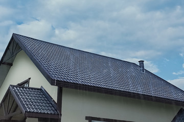 Fototapeta na wymiar Corrugated metal roof and metal roofing. Modern roof made of met