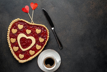 coffee, heart-shaped cake, a gift with a red ribbon for Valentine's Day on  stone background, with copy space for your text. breakfast concept on  saint's day  Valentine.