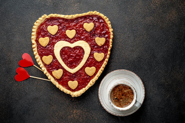 coffee, heart-shaped cake, a gift with a red ribbon for Valentine's Day on  stone background, with copy space for your text. breakfast concept on  saint's day  Valentine.