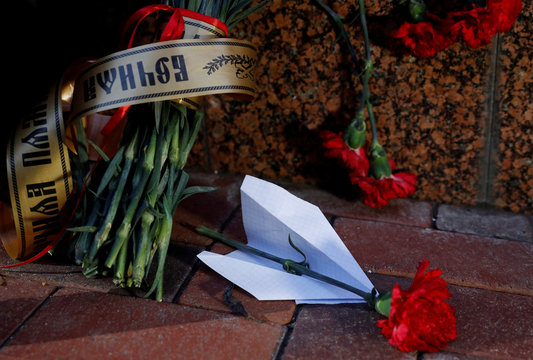 Flowers and a paper plane are placed outside the Iranian Embassy to commemorate the victims of the Ukraine International Airlines flight PS752 plane crash