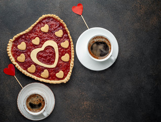 two coffee, heart-shaped cake for valentines day on  stone background, with copy space for your text. breakfast concept on  saint's day  Valentine.