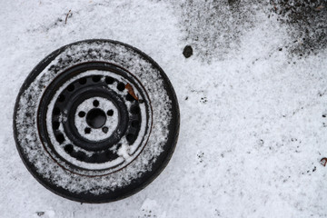 Snow powder tire. Black tire in the snow