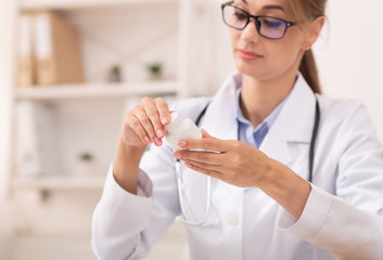 Doctor Holding Pills Reading The Ingredients Of Medicine In Office