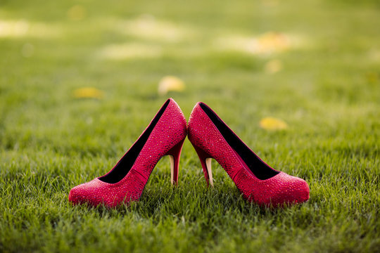 red sparkling high heel shoes on grass