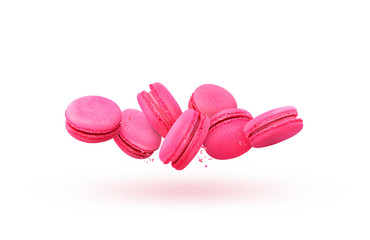 Pink macaroons in motion falling on a white background. Sweet and colorful french macaroons fall or fly in motion.