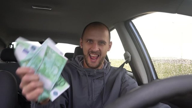 Happy driver with big money euro. Success. Concept on the business success, topic of lottery, winnings, slot machines.