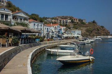 Fototapeta na wymiar promenade with mediterranean flair at the enchanting harbor of Evdilos, Ikaria, Greek Islands, Greece