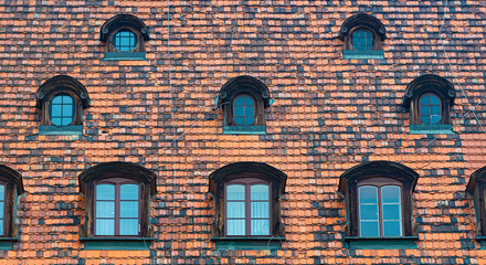 Tiled house roof with window in Wroclaw, Poland