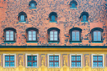 Obraz premium Tiled house roof with window in Wroclaw, Poland