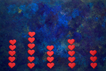 Blue oil paint mixed. Columns of hearts. Valentines day concept.