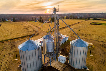 Aerial of Midwestern Farm including silos at dusk © Aaron