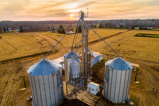 Aerial of Midwestern Farm including silos at dusk