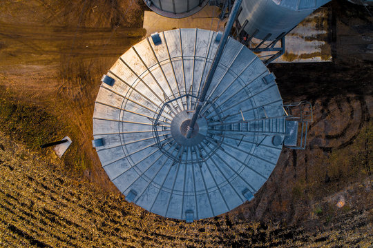 Aerial of Midwestern Farm including silos at dusk