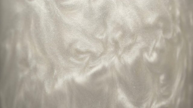 Rheoscopic fluid. Beautiful movement of particles in a liquid. Fantastic patterns and shapes.