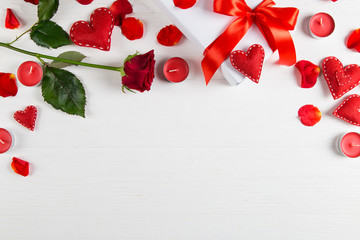 Gift with red ribbon, red rose and heart on a white background. The concept for Valentine's Day, a romantic gift to a loved one for the holiday.