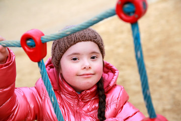 Fototapeta na wymiar Portrait of beautiful girl on the playground