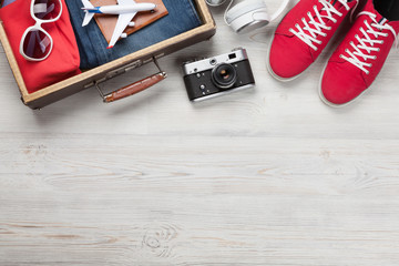 Suitcase with clothes and travel accessories