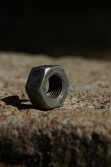 One bolt nut over a brick 1