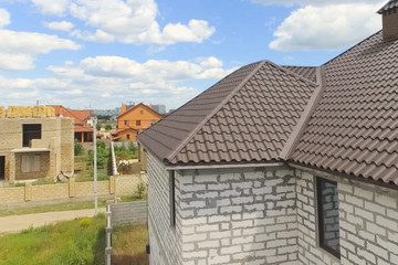Fototapeta na wymiar Corrugated metal roof and metal roofing. Modern roof made of met