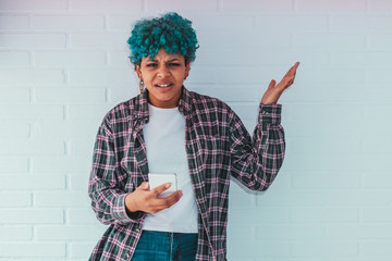 young girl with fashionable mobile phone with expression of misunderstanding