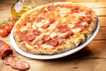 pizza with salami on the wooden table