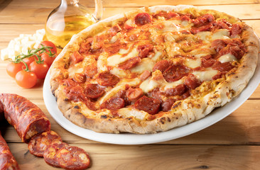 pizza with salami on the wooden table